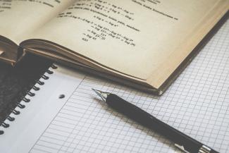 Libro de fórmulas, cuaderno y lápiz